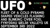 UFO – Fleet of 6 pyramid shaped vehicles glistening gold over Foel Fynyddau Wales UK