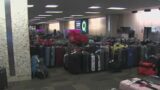 Rows of lost luggage line Tampa airport: 'Each bag represents a person'