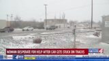 Woman desperate for help after car gets stuck on tracks