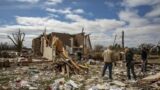 US tornadoes: Clean-up begins after at least 26 killed in monster storm