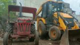 jcb3dx backhoe loader loading broken pieces of brick in Mahindra tractor and sonalika tractor
