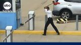 Pilot arrested after swinging ax on parking lot gate