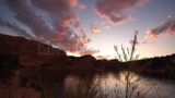 Stock Video – View of sunset at Red Fleet Reservoir in Utah moving past bush