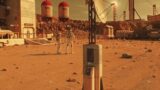 Two astronauts walk on Mars surface on research station