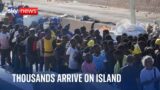 Lampedusa: Thousands of migrants arrive on Italian island