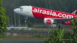Airbus A320 of AirAsia taking off, side view