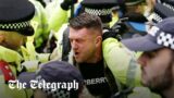 Police bundle Tommy Robinson out of the antisemitic London march as he's 'not welcome'