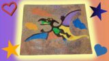 Malowanie piaskiem, dinozaur pterodaktyl. Sand painting, pterodactyl dinosaur, for children.