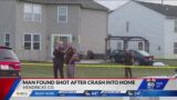 Man found shot to death after vehicle crashes into home