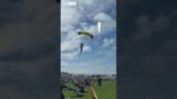 Moment parachutist lands on spectators